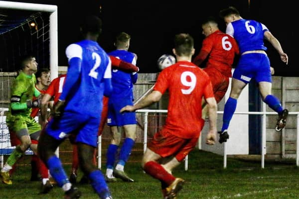 Josh Westwood heads a late winner for Squires Gate against Garstang. Photo: Ian Moore