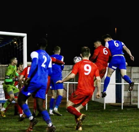 Josh Westwood heads a late winner for Squires Gate against Garstang. Photo: Ian Moore