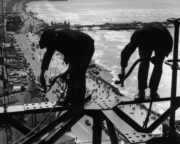 Balancing on girders high above the promenade workmen repair Blackpool Tower, 1934