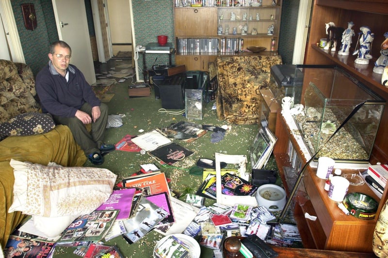 Michael Ray, of Charles Court in Layton, sits disconsolately amidst the wreckage of his flat, which was systematically destroyed by an alleged drug dealer in 2000