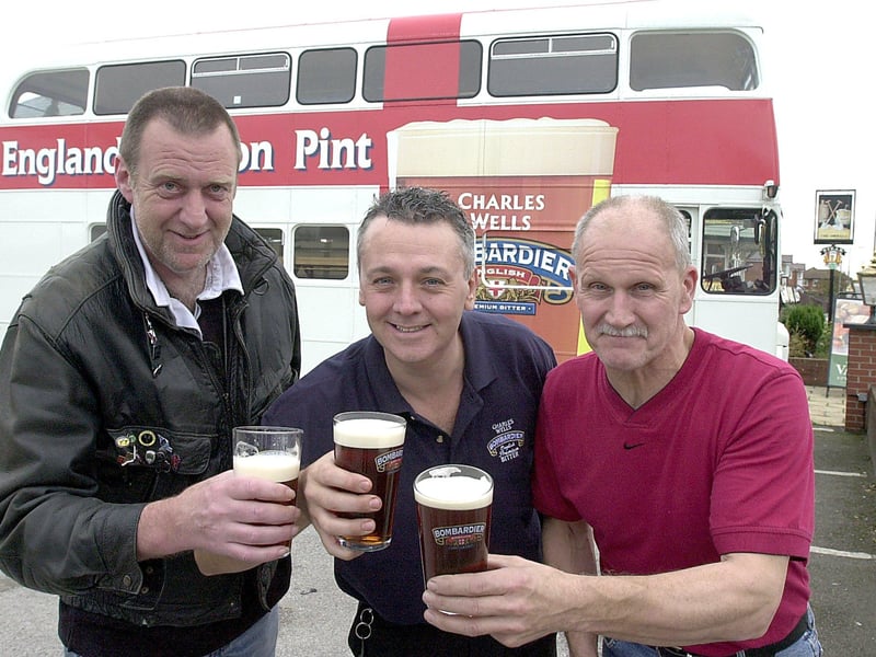 Shovels Landlord Steve Norris (centre) with his brother Albert Norris (right) pub regular Gordon Stuteley with the Charles Wells bus at the start of the annual Beer Festival, 2002