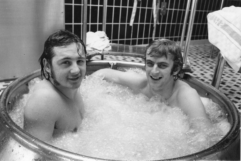 Manchester United players Paddy Roache and Dave McCreery enjoy a dip in a hot tub at Derby Baths