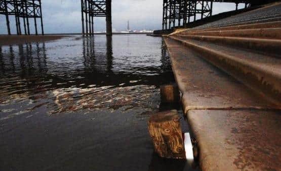 An image from the report shows the existing coastal defences with intertidal channel and exposed defence toe, Nov 2021