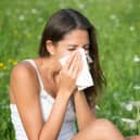 The most common symptoms of hayfever include sneezing and an itchy or irritated throat. Photo: 4FR / Getty Images / Canva Pro.