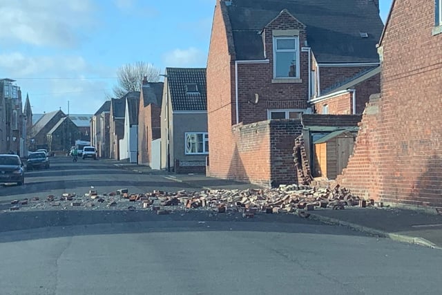 Storm Malik causes a brick wall to partially collapse, spilling onto the road in Roker, Sunderland
