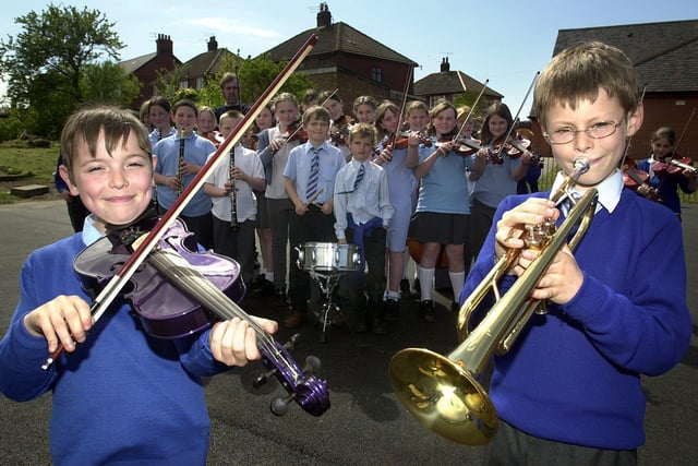 Taran Cameron and Mark Phillips with members of the Layton Primary School orchestra which had been chosen to take part in a national festival in London