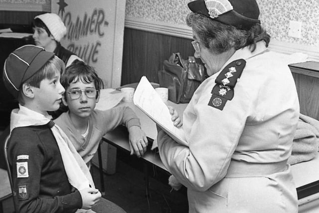 Under examination after completing an arm sling is Stuart Rimmer ( left) whilst the patient, Kevin Hewitt (centre) looks on. Conducting the first aid questioning is Mrs Marjorie Moorby. The boys were taking part in the Lonsdale District Cub Scouts first aid competition in Morecambe