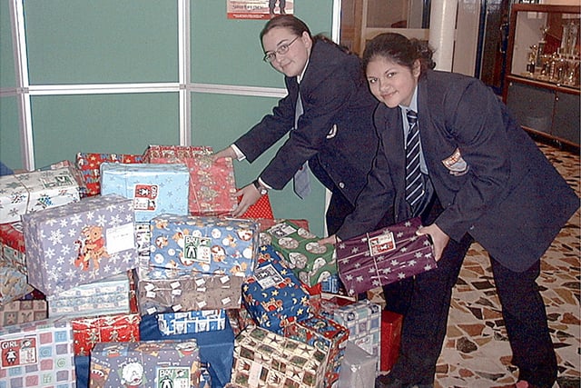 Collegiate High School pupils Kelly Lam and Kathrine Mladenovic, sorting out the donations for operation Christmas Child, 2001
