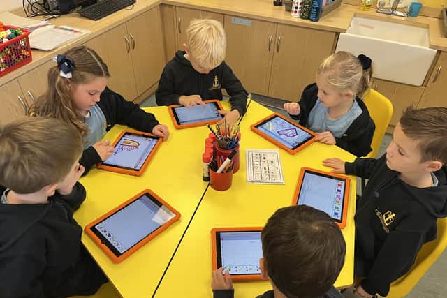 The school says the iPads provide a new way of learning as well as enhancing traditional ways.