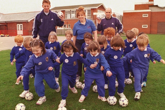 Adidas Schools Football Initiative, at King Edward VII and Queen Mary School, Lytham - to raise money for student nursery nurse Amanda Chapman  to visit Nepal). Pictured with some of the reception class, are coaches Austin Speight (right) and Peter Duckworth with Amanda Chapman