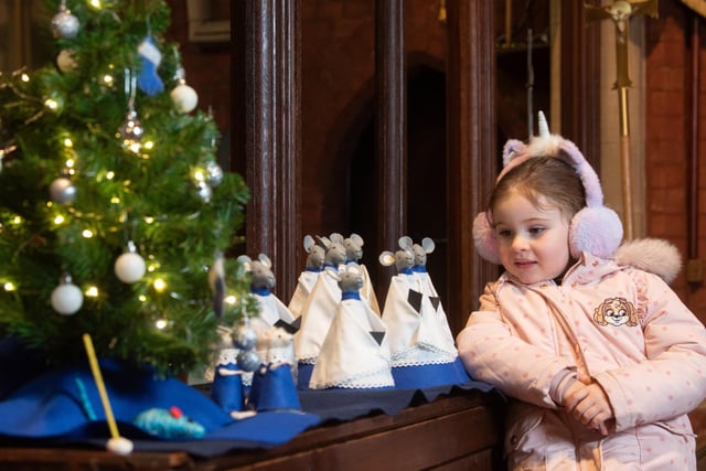 Maizie Martin admires the displays at St Annes Parish Church Christmas Tree Festival.