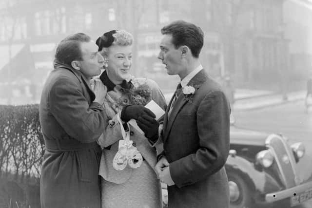 Pictured in 1955: comedian Charlie Chester steals a kiss from bride Mrs Joan Savage while husband Ken Morris looks on.