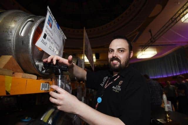 Matt Walker pours a pint behind the bar at Fleetwood Beer and Cider Festival in 2022. Photo: Michelle Adamson