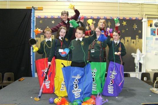 Chris Ryden of Garstang's Sainsbury's store presents youngsters at St Thomas's School, Garstang, with activity sacks and packs as part of a Christmas gift to the school
