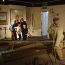 A family observes one of the exhibits at Fleetwood Museum
