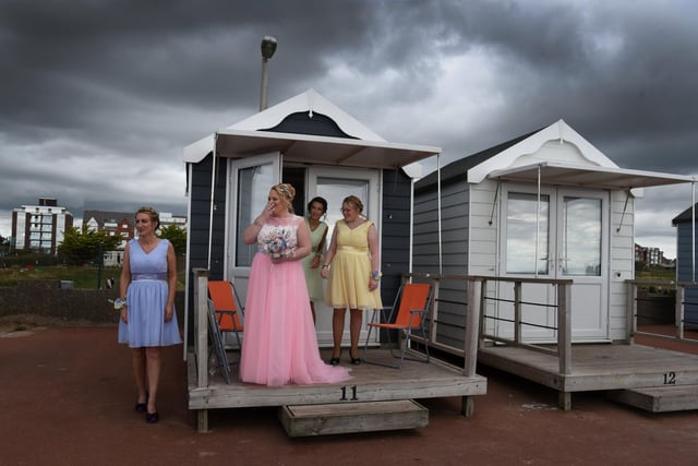 Louise prepared for the ceremony in a beach hut overlooking the sands. Picture: Neil Cross.