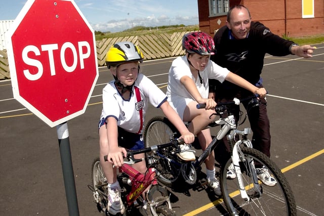 Children at King Edward and Queen Mary Junior School taking part in a safer cycling scheme in their playground. Pictured left to right are Jessica Dawson, Alistair Marquis-Carr, and John Rice from Lancashire County Council