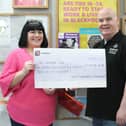 Shaun presents the cheque to Kim Hughes supported by Ben Gorry