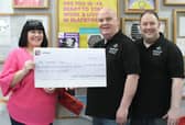 Shaun presents the cheque to Kim Hughes supported by Ben Gorry