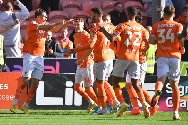 Yates celebrates with Gary Madine after the two combined for Blackpool's first goal in the derby