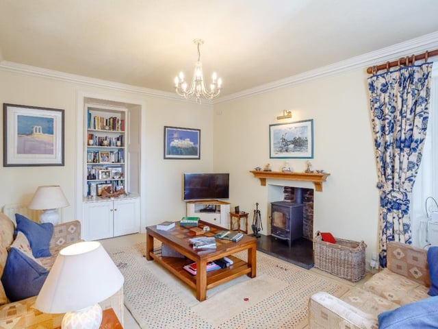 Family room with wood burning stove and bespoke recessed storage.