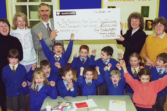 The After School Care Club at St Nicholas CE Primary School received a cheque for £2,500, from LAWTEC in 1997. Pictured are some of the children at the club with supervisor Christine Walsh,  club assistant Carole Rowlinson, LAWTEC childcare co-ordinator Graham Brandwood, school headteacher Sandra Gillibrand and deputy headteacher Anne Parrott