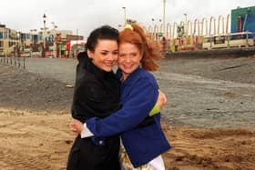 Patsy Palmer and Martine McCutcheon who played the iconic Eastenders characters Patsy Palmer and Tiffany, brave Blackpool's weather on the beach during a filming session in 1996