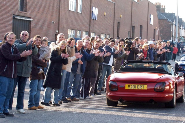 TVR owners are applauded as they drive past workers at the troubled Blackpool car factory in Bristol Avenue