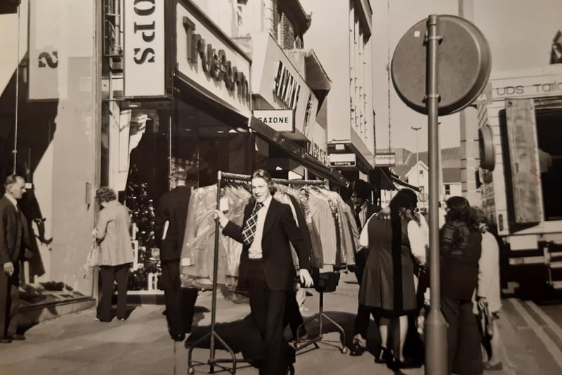 The new pedestrian 'precinct' was causing difficulties for deliveries to shops outside the allotted time in this 1971 photo. The caption reads 'sometimes racks of dresses and suits have to be trundled along the pavement through the crowds'