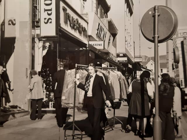 The new pedestrian 'precinct' was causing difficulties for deliveries to shops outside the allotted time in this 1971 photo. The caption reads 'sometimes racks of dresses and suits have to be trundled along the pavement through the crowds'
