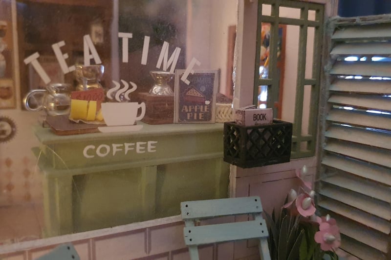 I love the realistic details within this little coffee shop. It has opening doors, miniature chairs, and a realistic decking - all painted and glued by hand.