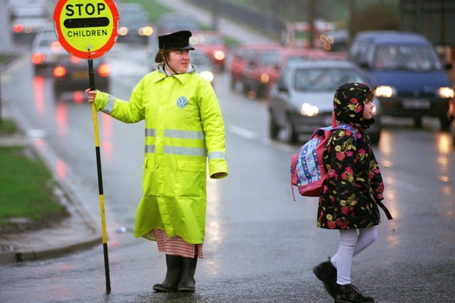Lollipop lady Lisa Hannis sees another youngster safely across the road at Blackpool's busy Plymouth Rd roundabout in 1998