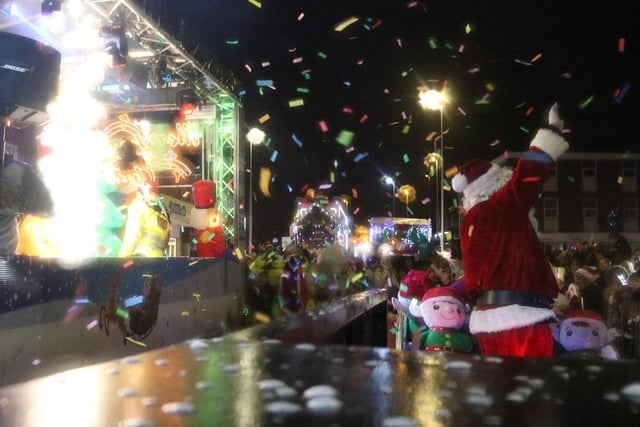 .A shower of coloured paper flies through the air as Santa addresses the crowd in Bispham Photo: Steve Eaves