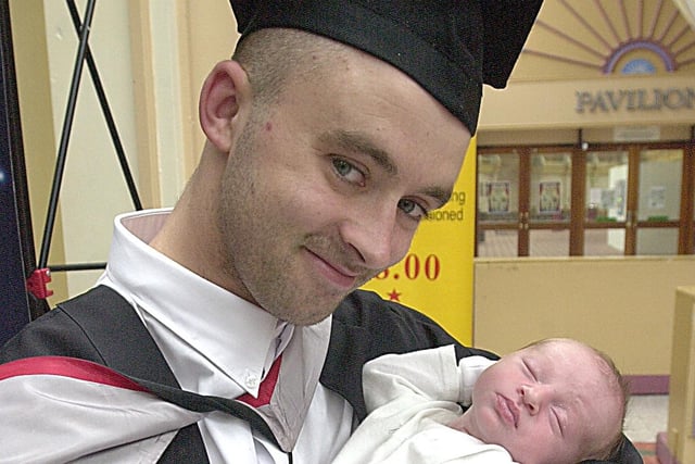 Graduate Trevor Ashton with his two weeks old son Khai in 2002