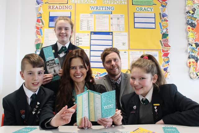 Armfield Academy students using the secondary school bookmark which has been picked up by the SHINE trust to broaden pupils' vocabulary. Left to right Armfield Pic - Left to right - Jack Ashton, Maisie Coxhill, Estelle Bellamy (FCAT Director of English), Karl Moon (Armfield Academy Head of English) and Mollie Binks