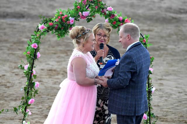 Karen Harrison conducts the wedding of Lou Wiltshire and Shaun McGilloway on St Annes beach. Photo Neil Cross.