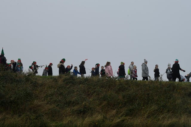 Staff, pupils and parents silhouetted against the sky  during the Elf run at Chaucer School, Fleetwood. Photo Neil Cross