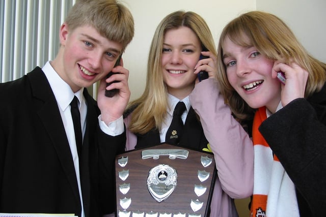 James Geer (chairperson), Elaine Tyler (speaker) and Elizabeth Broughton (Vote of Thanks) phoning home with the good news after South Fylde Rotary Public Speaking Competition in 2002