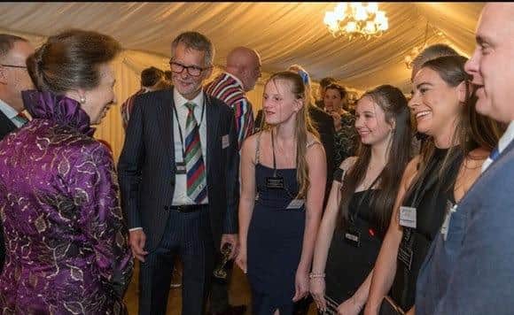 Maddie Marsden, 15, (far left) who has been recognised as a project champion by Wooden Spoon, the children’s charity of rugby as the charity is pictured chatting to Anne, Princess Royal