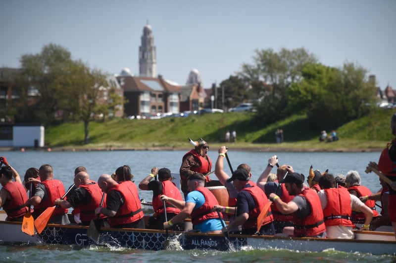 The White Church provides a scene backdrop to the Blue Skies Dragon Boat Festival at Fairhaven Lake.