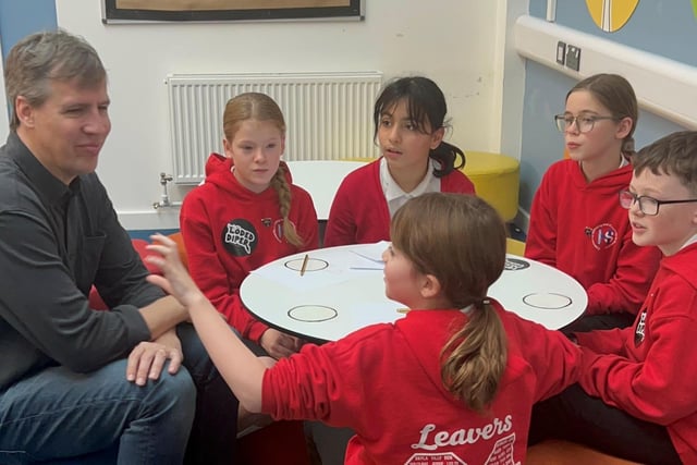 Jeff Kinney is all ears as he listens to pupils at Hawes Side Academy