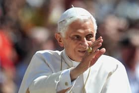 Pope Benedict XVI waves to crowds in 2012