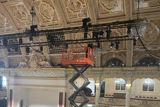 Work is underway to polish the chandelier at the Empress Ballroom