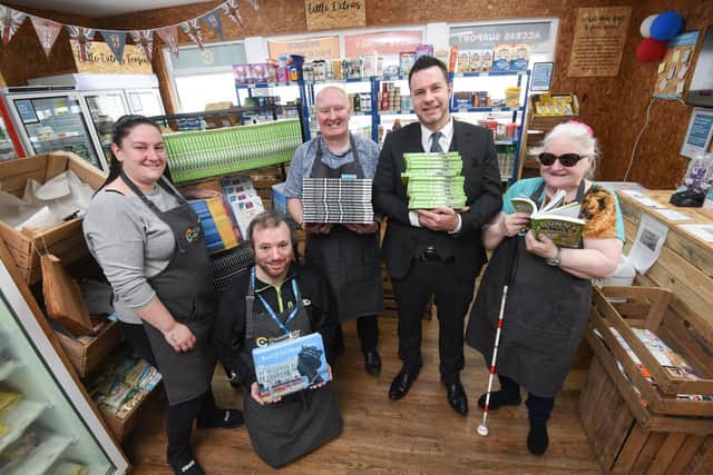Alishia Dawson, Arron Simpson Chris Lowry, Peter Wright and Linda Newlands with books donated to the Community Grocery in Blackpool