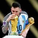 Argentina's Lionel Messi kisses the FIFA World Cup trophy after being presented with the Golden Ball award  (Nick Potts/PA Wire)