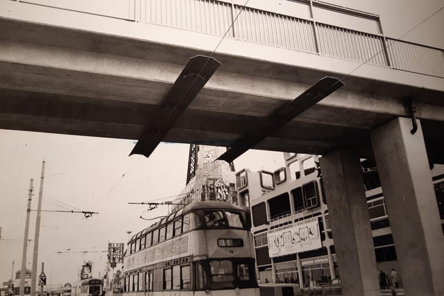 Metal strips anchored the tramway's overhead cables to the underside of the footbridge. Hard board panels were put in place to prevent people interfering with them