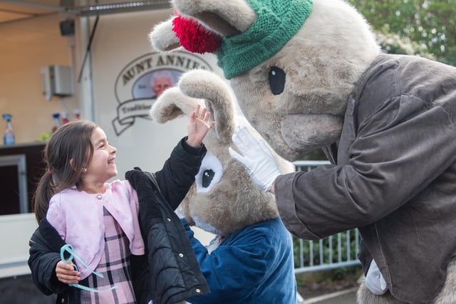 Six-year-old Amaya McRandle high fives a bunny at Lowther's Easter Surprise weekend.
