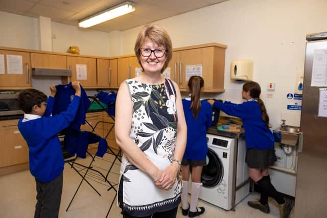 Executive Headteacher, Sarah Smith visits the laundry facilities at St. Cuthbert's Catholic Academy in Blackpool, which have been provided by smol in collaboration with The Hygiene Bank for their Suds in Schools initiative, launched following research that revealed a significant increase in children experiencing hygiene poverty in the past year. Photo credit: James Speakman/PA Wire