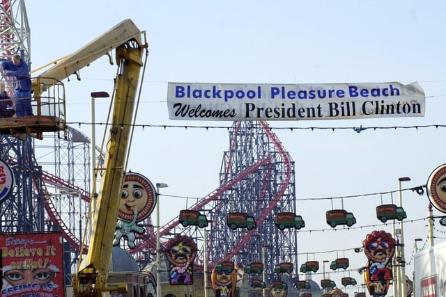 Workmen erect a banner outside Blackpool Pleasure Beach to welcome President Bill Clinton