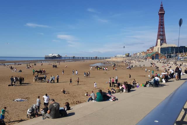 People enjoying Blackpool beach on a sunny day